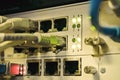 Front panel of an old internet switch. Network interfaces and cables are interconnected. Communication wires connect to equipment