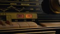 Front panel of vintage radio with radio wave frequency, buttons and knob. Dashboard of an analog old radio close up Royalty Free Stock Photo