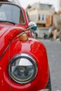 Front part of a classic car with a round headlights. Fancy vintage retro car attracting the attention of visitors and amateurs of Royalty Free Stock Photo