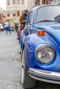 Front part of a classic car with a round headlights. Fancy vintage retro car attracting the attention of visitors and amateurs of Royalty Free Stock Photo