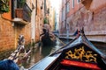 The front part of the gondola under the bridge of Venice