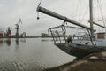 Front part of the mooring yacht in Docks on the Martwa Wisla in Poland city of GdaÃâsk with port cranes in background during the