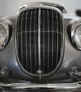 Front part of an old retro antique car with grille and headlights Royalty Free Stock Photo