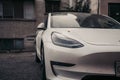 Front part of a white car in the rain. Royalty Free Stock Photo