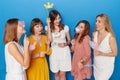 Front photo of a group of joyful women to have gender reveals envent, isolated blue background.