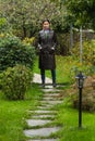 Imposing woman standing in garden