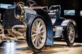 Front photo. Stylish gilded old car with two seats and high steering wheel