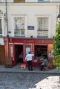 The front of a picturesque cafe in Montmartre being painted