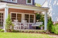 Front Porch America Porch Swing and two rocking chairs and a cat Royalty Free Stock Photo