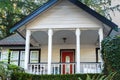 Front porch of the American house with red door. Small old house with entrance porch. Real Estate Exterior Front House Royalty Free Stock Photo