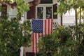 Front porch with American flag and greenery Royalty Free Stock Photo
