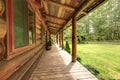 Front porch of the old rustic log cabin. Royalty Free Stock Photo