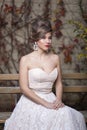 Front portrait of a beautiful bride with wedding makeup and hairstyle, gorgeous young woman in white dress. Vertical view Royalty Free Stock Photo