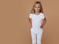 Front portrait of pretty little cute girl with wavy hair, dressed in white clothes. Fashion photo. Horizontal view Royalty Free Stock Photo