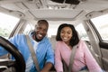 Happy black couple sitting in car posing at camera Royalty Free Stock Photo