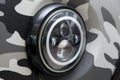 Round headlamp view of gray car with led day running DRL light and bi-xenon lens Royalty Free Stock Photo