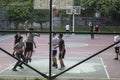 Front shoot of children playing basketball on the street hall