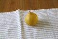 Front shot of a lemon over a kitchen towel