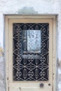 Front shot of traditional ornamented pale yellow metal door