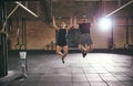 Front shot of two sportsmen doing pull-ups