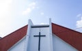 Front side of church building with cross in the morning