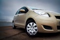 Front-side closeup of a beige car