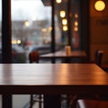 Front side of empty wooden table for product display, blurred cafe interior background. Warm and calm evening ambiance with Royalty Free Stock Photo
