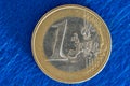 front side of 1 euro coin under blue cloth background Royalty Free Stock Photo