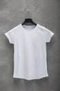 Front side of female white cotton t-shirt on a hanger Royalty Free Stock Photo