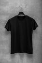 Front side of male black cotton t-shirt on a hanger Royalty Free Stock Photo