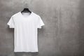 Front side of male white cotton t-shirt on a hanger