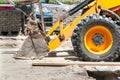 Front side shovel and tire of earth mover and loader bulldozer excavator construction machinery on the street Royalty Free Stock Photo