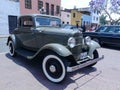 Front and side view of a green Ford De Luxe coupe two doors exhibited in Lima Royalty Free Stock Photo