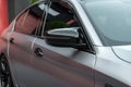 Front side view of the metallic color modern sports car close up. Rearview mirror and doors. Exterior detail. Royalty Free Stock Photo