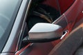 Front side view of metallic color modern sports car close up. Rearview mirror. Exterior detail. Royalty Free Stock Photo