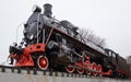 Front side view of old classic black steam locomotive with red decoration Royalty Free Stock Photo