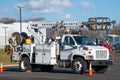 Front and side view of parked communication utility trucks in residential neighborhood