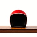 Front side view of red color vintage style motorcycle helmet on natural wooden desk.Concept classic object isolated Royalty Free Stock Photo