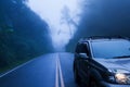 SUV car on a mountain road in the mist