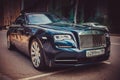 Front side view of a very expensive premium Rolls-Royce Dawn car, luxury dark blue convertible