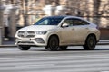 Front side view of white crossover mercedes benz gle coupe in motion. Mercedes-benz w167 suv car drive on the street