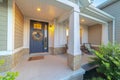 Front and sidelight of home with front porch and wood siding exetrior wall