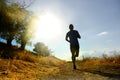 Front silhouette young sport man running cross country workout at summer sunset Royalty Free Stock Photo