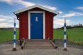 Front of a small clean public bathroom in the countryside in Sweden Royalty Free Stock Photo