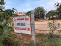 In front of Sri Kamadhenu Kshetra located tourist office arrange tour to place and timing board with flex banner Royalty Free Stock Photo