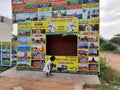 In front of Sri Kamadhenu Kshetra located tourist office arrange tour to place and timing board with flex banner Royalty Free Stock Photo