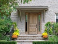 Front steps of stone house with wood grain front door