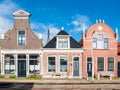 Front of three historic houses in old town of Workum, Friesland