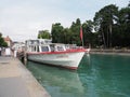 Front of touristic white boat moored at promenade on alpine Lake Annecy landscape in France Royalty Free Stock Photo