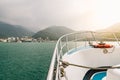Front of travel boat with lifebuoy and golden light over Sun Moon Lake with mountain and town in background in Yuchi Township. Royalty Free Stock Photo